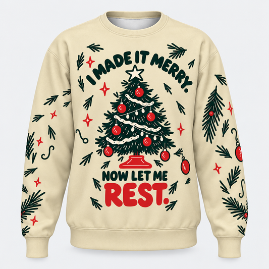 A cream-colored crewneck sweatshirt featuring a festive Christmas tree graphic with the text 'I MADE IT MERRY. NOW LET ME REST.